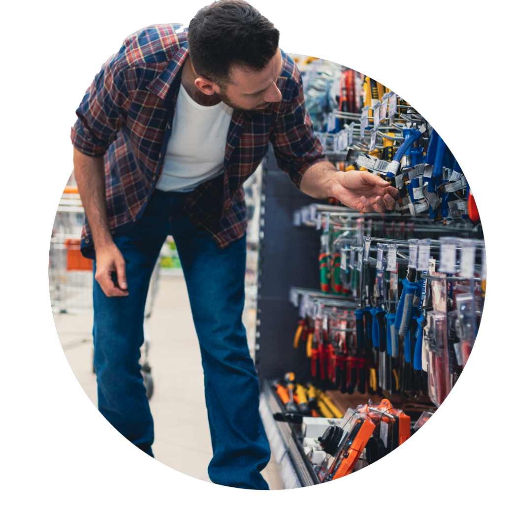 man looking at items in a hardware store